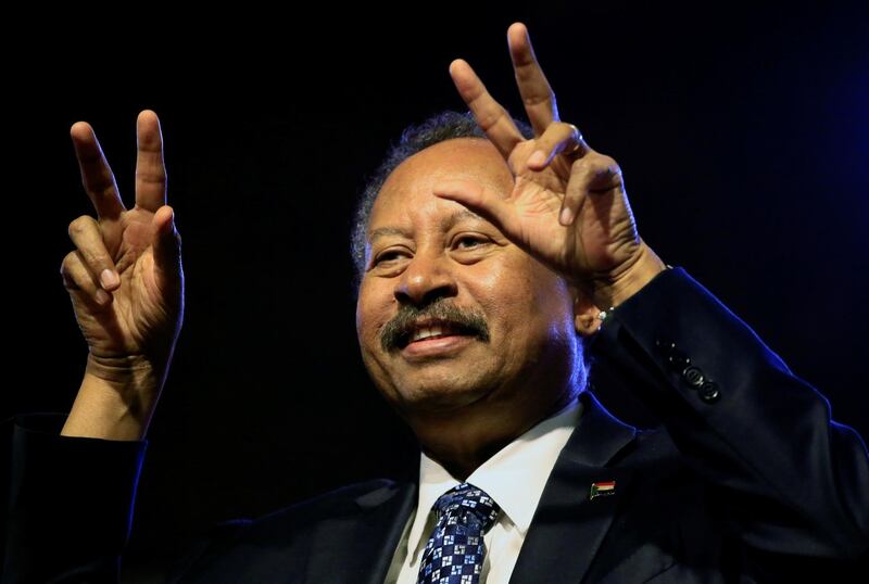 Sudan's Prime Minister in the transitional government Abdalla Hamdok gestures the victory sign during the first anniversary of the start of the uprising that toppled long-time ruler Omar al-Bashir, at the Friendship Hall in Khartoum, Sudan December 25, 2019. Picture taken December 25, 2019. REUTERS/Mohamed Nureldin Abdallah