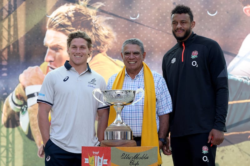 Michael Hooper (L), Mark Ella (C) and Courtney Lawes pose for pictures with the Ella Mobbs trophy. AFP