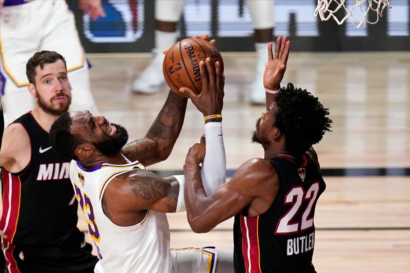 Lakers' LeBron James battles with Jimmy Butler of Miami. AP