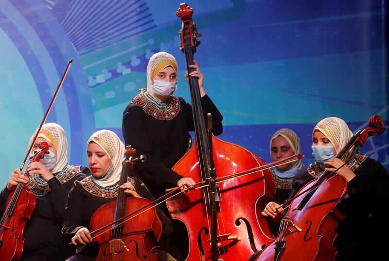 Members of Al Nour Wal Amal (Light and Hope) chamber orchestra for blind women wearing protective masks play during their first concert at the Manasterly Palace in Cairo, Egypt on September 20, 2020. Reuters