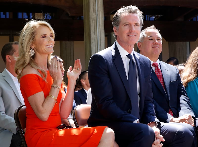 Mr Newsom and Ms Siebel Newsom attend a signing ceremony at Sacramento Community College in 2019. AP