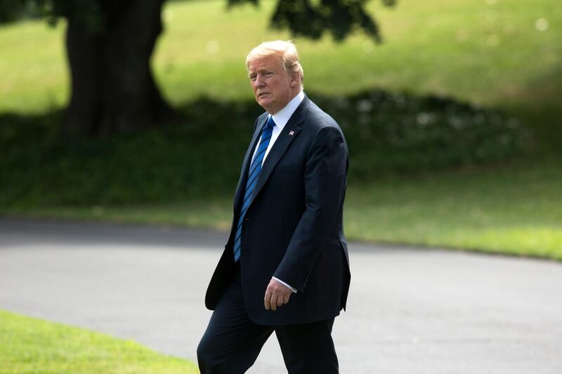 epa06901336 US President Donald J. Trump walks on the South Lawn to depart the White House by Marine One, in Washington, DC, USA, 20 July 2018. Trump travels to Bedminster, New Jersey, for the weekend.  EPA/MICHAEL REYNOLDS