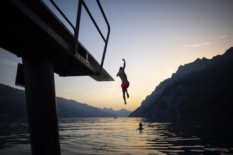 Youth enjoy the evening on lake Walensee in Walenstadt, Switzerland. The country was hit by a heatwave with temperatures up to 39 degrees Celsius.  EPA
