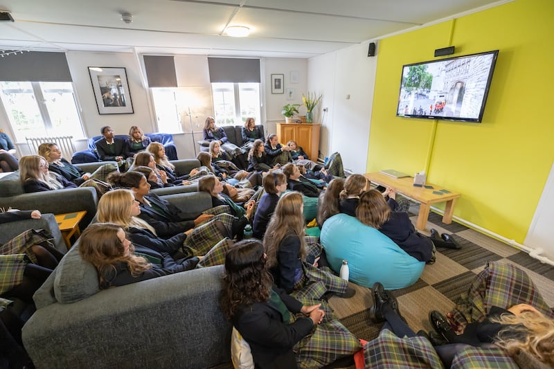 Pupils watch the state funeral of Queen Elizabeth II in their boarding house, Windmill Lodge, at Gordonstoun, September 19, 2022. 