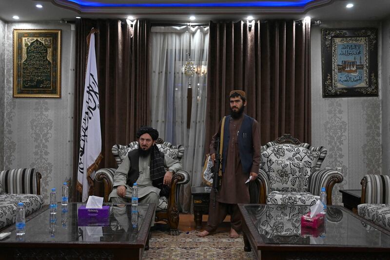 Qari Salahuddin Ayoubi, left, one of the military commanders of the Taliban, watches after an interview with AFP inside the home of the Afghan warlord Abdul Rashid Dostum in the Sherpur neighborhood of Kabul. AFP