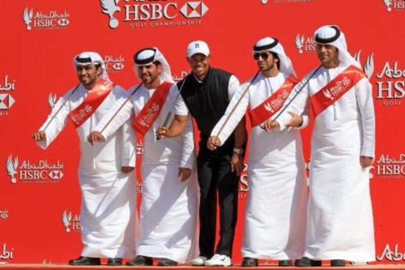 ABU DHABI, UNITED ARAB EMIRATES - JANUARY 24:  Tiger Woods of the USA moves to the beat with members of a traditional Emirati Ayala dance troupe as a preview for the 2012 Abu Dhabi HSBC Golf Championship at the Abu Dhabi Golf Club on January 24, 2012 in Abu Dhabi, United Arab Emirates.  (Photo by David Cannon/Getty Images) *** Local Caption ***  137630251.jpg