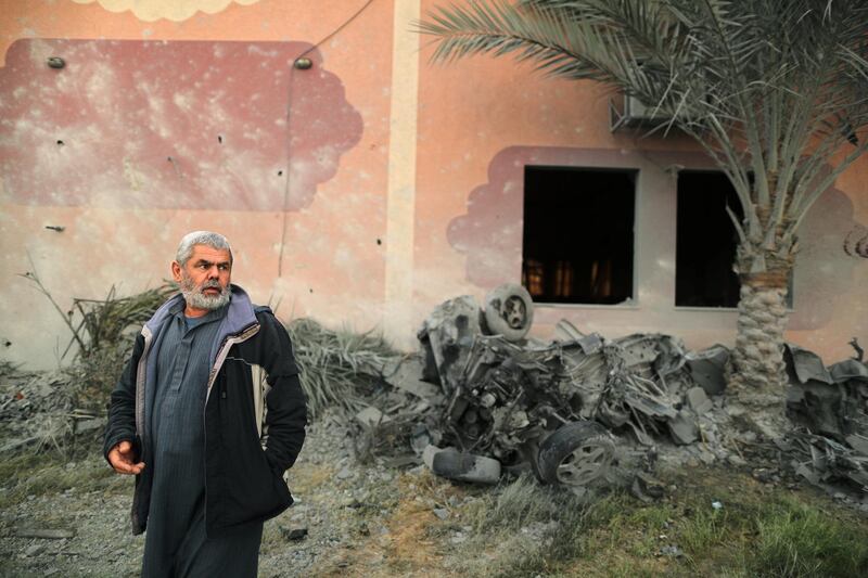 A Palestinian man looks on as he inspects the scene of Israeli air strikes. Reuters