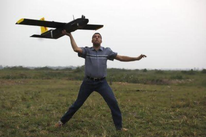 Remo Peduzzi, managing director of ResearchDrones LLC Switzerland prepares to fly an unmanned aircraft at the Kaziranga National Park in Assam state, India.