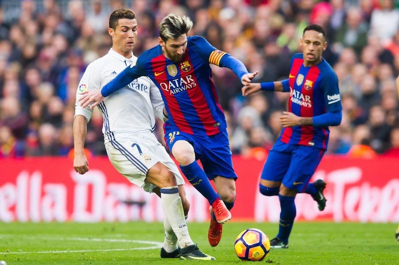 Lionel Messi vies for possession with Cristiano Ronaldo during the Barcelona-Real Madrid match on December 3, 2016, at Camp Nou in Barcelona, Spain. Alex Caparros / Getty Images