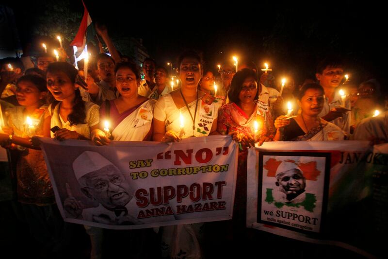 Supporters of anti-corruption activist Anna Hazare hold a candlelight vigil in Gauhati, India, Thursday, Aug. 18, 2011. The renowned Indian anti-corruption crusader struck a deal with police Thursday to hold a 15-day public hunger strike against graft, ending a standoff at a New Delhi prison in which he turned his brief detention into a sit-in protest.(AP Photo/ Anupam Nath) *** Local Caption ***  APTOPIX India Anna protest.JPEG-0f201.jpg