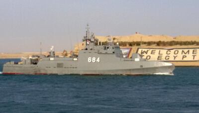 A picture taken with a smartphone on March 26, 2015 shows an Egyptian navy Ezzat-class ship passing through the Suez Canal, by the Egyptian city of Ismailia, 100 kilometers northeast of Cairo, on it's way to the Red Sea. Egypt's air force and Navy are participating in  the Saudi-led intervention "Firmness Storm" against Shiite Huthi rebels in Yemen. AFP PHOTO / YASSEN MOHAMED (Photo by YASSEN MOHAMED / AFP)