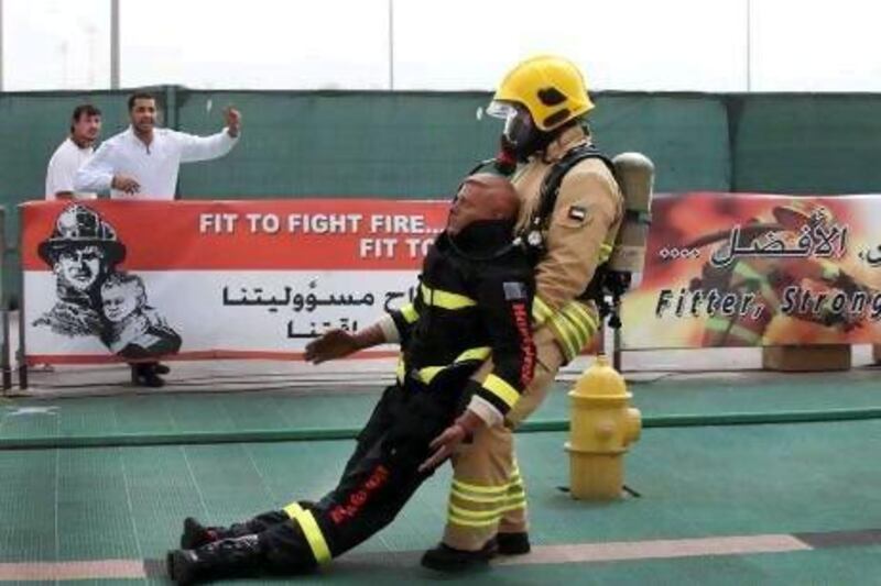 Maged Ahmad Khalifa of AssetCo is cheered on during the individual competition where firefighters from all over the UAE competed in the Firefighter Championship at Adnec.