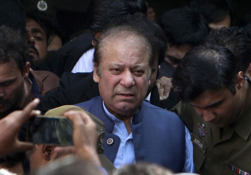 FILE - In this Oct. 8, 2018, file photo, former Pakistani Prime Minister Nawaz Sharif leaves after appearing in a court in Lahore, Pakistan. Sharif, who was convicted of corruption, has left the country and is traveling to London for medical treatment. (AP Photo/K.M. Chaudary, File)