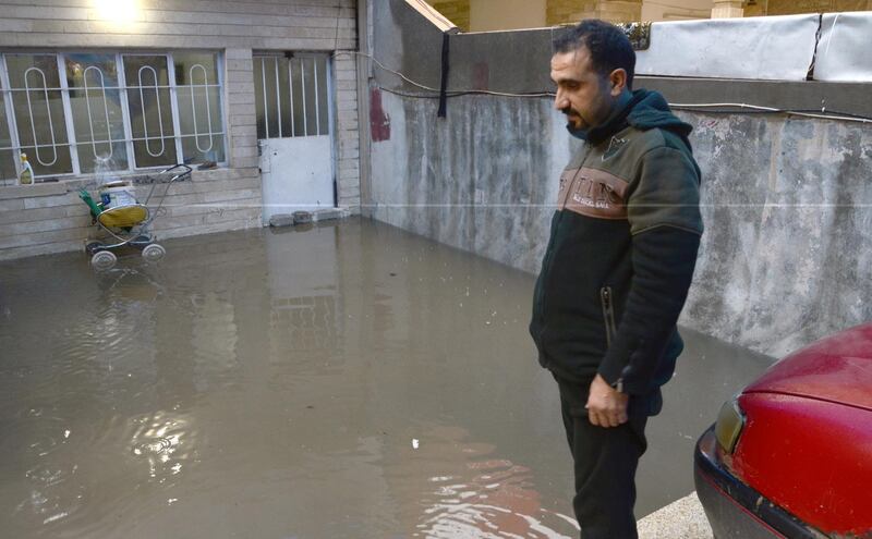 An Iraqi man stands at his flooded house in Mosul. EPA