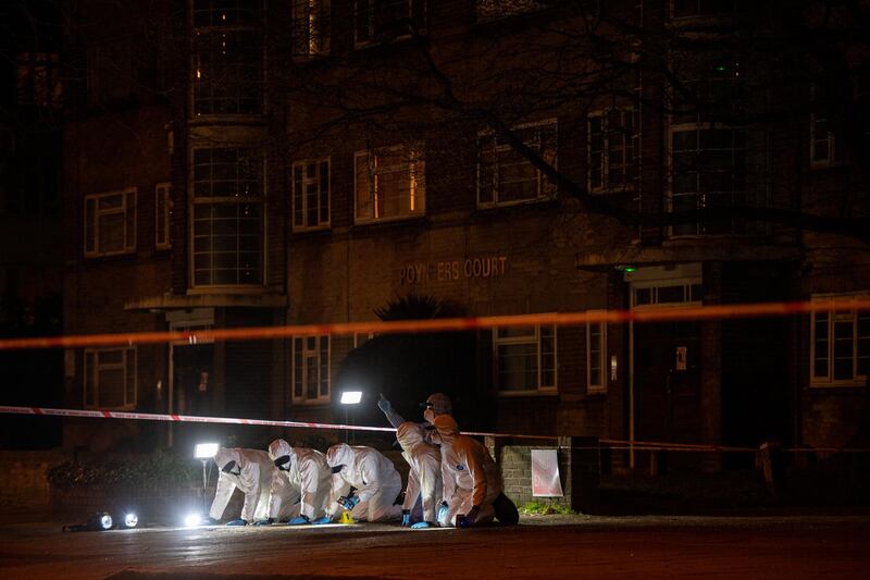 Police officers conduct a fingertip search of Poynders Road in London. Getty Images