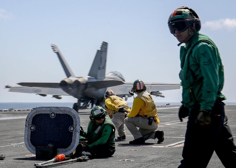 An F/A-18E Super Hornet from the Jolly Rogers of Strike Fighter Squadron 103 launches from the flight deck of the Nimitz-class aircraft carrier USS Abraham Lincoln on the Arabian Sea. AP