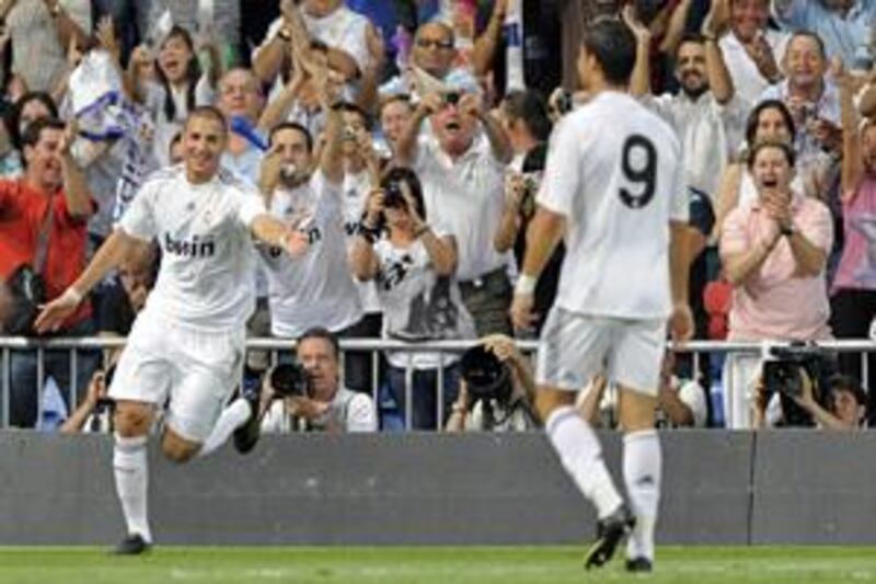 Real Madrid's Karim Benzema, left, celebrates after scoring against Rosenborg during a Santiago Bernabeu Trophy match in Madrid.