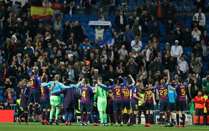 Barcelona players celebrate after a win that leaves them 12 points clear of Real. AP