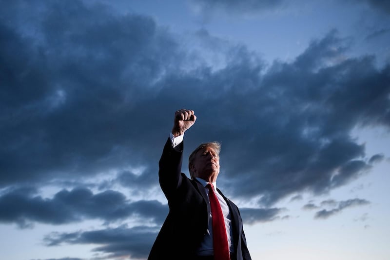 TOPSHOT - US President Donald Trump holds up his fist as he leaves after speaking during a Make America Great Again rally at Williamsport Regional Airport May 20, 2019, in Montoursville, Pennsylvania. / AFP / Brendan Smialowski
