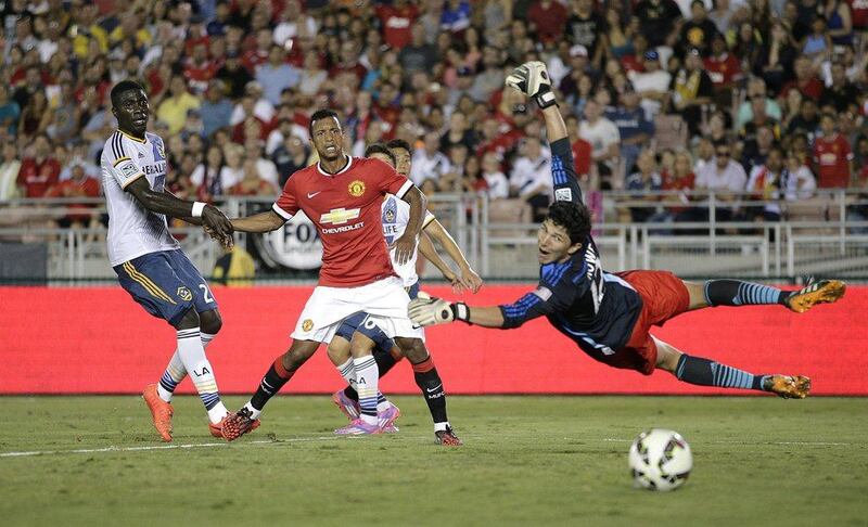 Nani, centre, of Manchester United, watches a shot by Shinji Kagawa as LA Galaxy's Kofi Opare, left, tries to defend and goalkeeper Brian Rowe, right, attempts a save. AP Photo