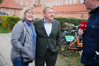 Former prime minister Lars Lokke Rasmussen, centre, with his wife at a polling station in Copenhagen. EPA 