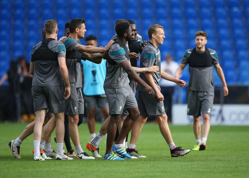 Lucas Leiva of Liverpool laughs with teammates during a Liverpool training session on the eve of the Europa League Final against Sevilla at St Jakob Park. Lars Baron / Getty Images