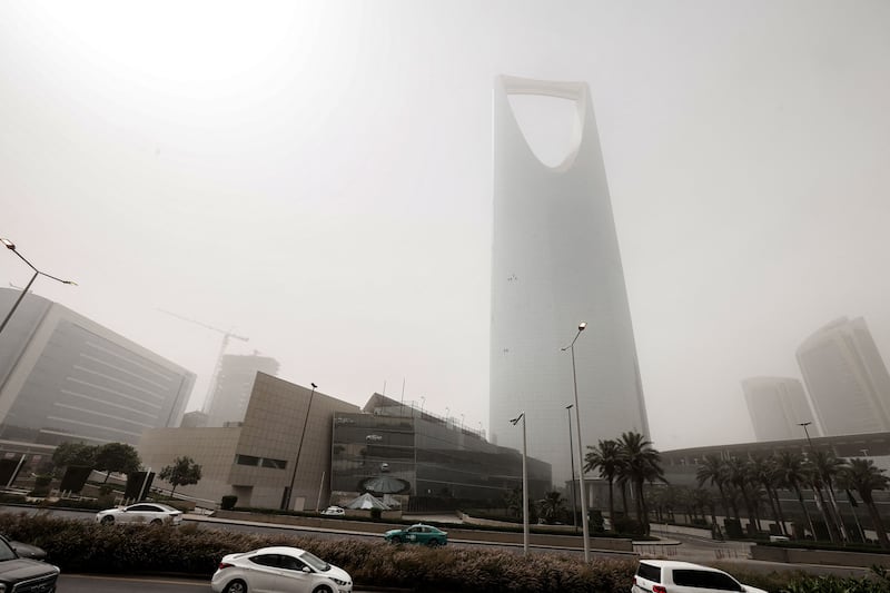 The 302-metre building is almost obscured by dust. AFP