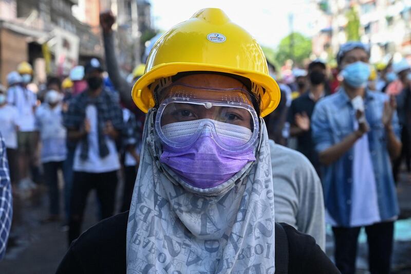 A protester wearing basic protective gear looks on during a demonstration against the military coup in Yangon. AFP
