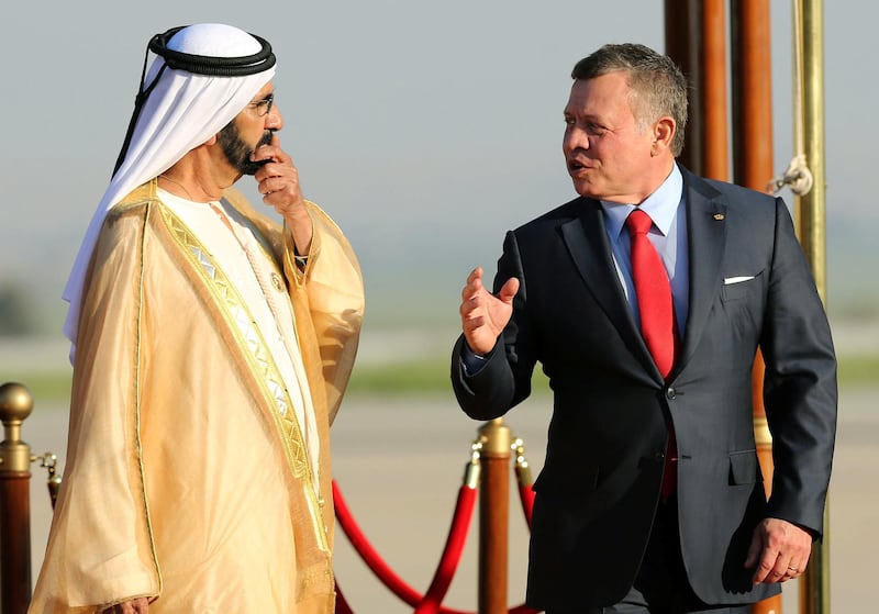 Jordan's King Abdullah II (R) talks with the Prime Minister of the United Arab Emirates (UAE) and ruler of Dubai Sheikh Mohammed bin Rashid al-Maktoum during a welcome ceremony at the Queen Alia International Airport in Amman on March 28, 2017 ahead of talks on the eve of the Arab League summit. (Photo by Khalil MAZRAAWI / AFP)