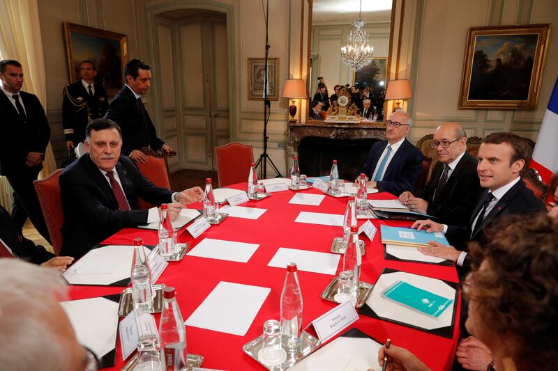 French President Emmanuel Macron (R) and Libyan Prime Minister Fayez al-Sarraj (L) attend a meeting for talks over a political deal to help end Libya’s crisis in La Celle-Saint-Cloud near Paris, France, July 25, 2017.  REUTERS/Philippe Wojazer