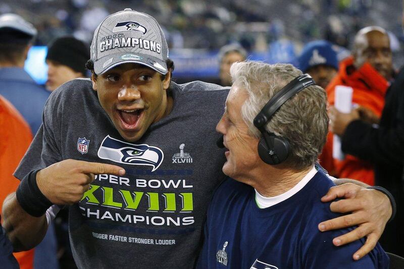 Quarterback Russell Wilson, left, and coach Pete Carroll do a postgame television interview following their victory in Super Bowl XLVIII on Sunday. Paul Sancya / AP