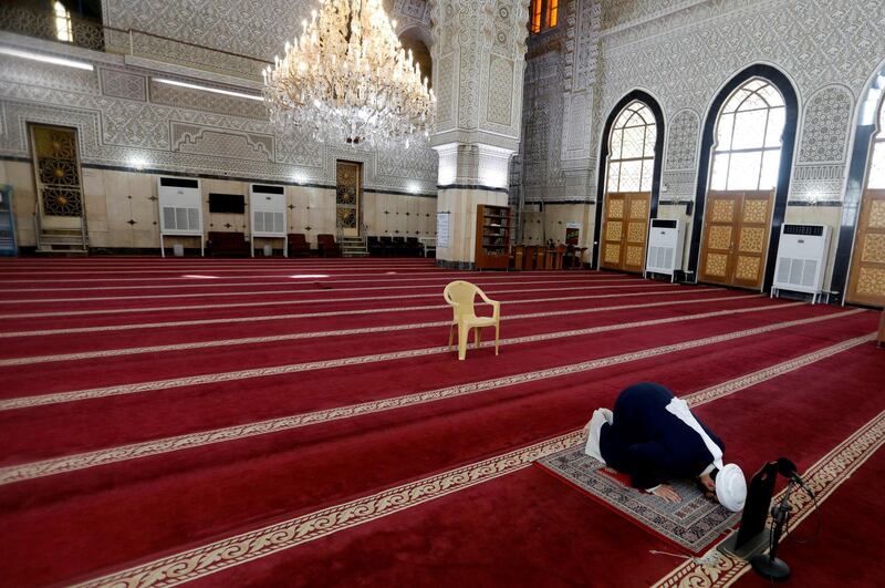 An Iraqi cleric prays in an empty mosque, as Friday prayers were suspended following the spread of the coronavirus disease (COVID-19), in Baghdad, Iraq. Reuters