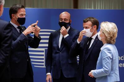 Dutch Prime Minister Mark Rutte, European Council President Charles Michel, French President Emmanuel Macron and European Commission President Ursula von der Leyen interact while wearing face masks during the last roundtable discussion following a four-day European summit at the European Council in Brussels, Belgium, July 21, 2020. Stephanie Lecocq/Pool via REUTERS