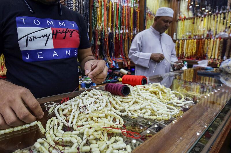 Vendors prepare prayer beads for sale at a market in Kuwait City during Ramadan. AFP