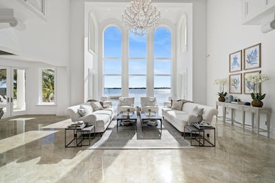 Floor-to-ceiling windows create a light and airy space. Courtesy Sotheby’s International Realty