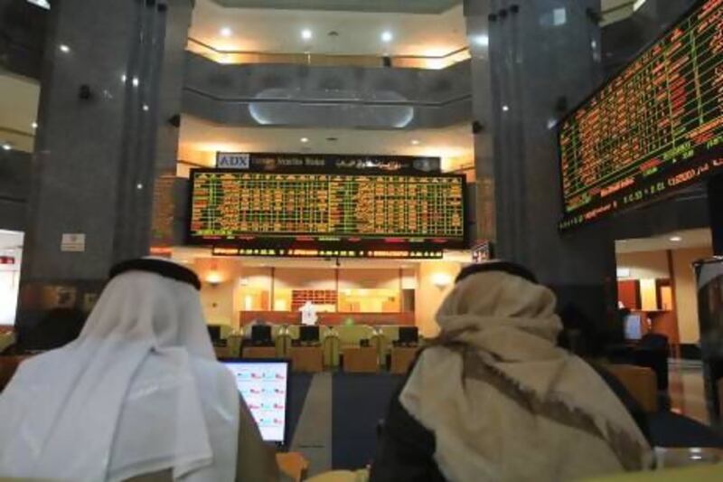 Shareholders watch the market at the Abu Dhabi Securities Exchange. Ravindranath K / The National
