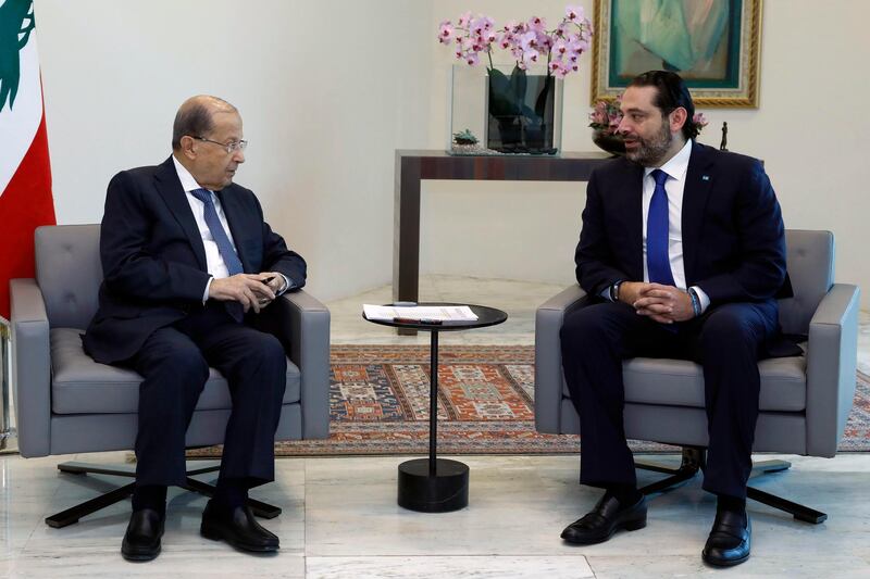 In this photo released by the Lebanese Government, Lebanese President Michel Aoun, left, meets with Prime Minister Saad Hariri, at the Presidential Palace in Baabda, east of Beirut, Lebanon, Thursday, May 24, 2018. Aoun held consultations Thursday with lawmakers on naming a new prime minister following this month's parliamentary elections and amid increasing pressures by the United States and its Arab allies on the militant Hezbollah group. (Dalati Nohra/Lebanese Government via AP)