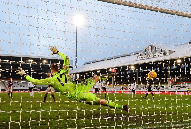 Fulham goalkeeper Marek Rodak is sent the wrong way as Jay Rodriguez scores from the spot for Burnley.