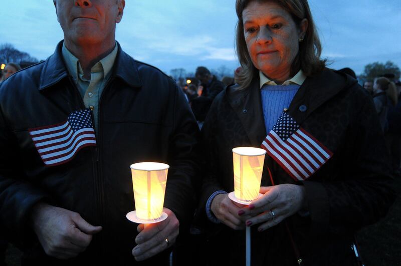 Tom and Nancy Gallagher attend a vigil ceremony  April 16, 2013 in Dorcester, Massachusetts honoring the Richard family, who's 8-year-old son Martin was killed,  sister Jane, who lost a leg, and mother Denise, who was also seriously injured when bombs exploded at the finish of the Boston Marathon April 15th.   AFP PHOTO/John MOTTERN
 *** Local Caption ***  926317-01-08.jpg