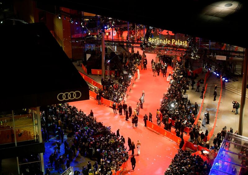 (FILES) This file photo taken on February 15, 2018 shows an overall view with guests and stars arriving on the red carpet for the opening ceremony of the 68th Berlinale film festival with the premiere of "Isle of Dogs" at the Berlinale Palace in Berlin. Berlin's international film festival said Friday, December 18, 2020 it was postponing its February 2021 edition as the coronavirus pandemic continues to take a brutal toll on the global entertainment industry. / AFP / Stefanie LOOS
