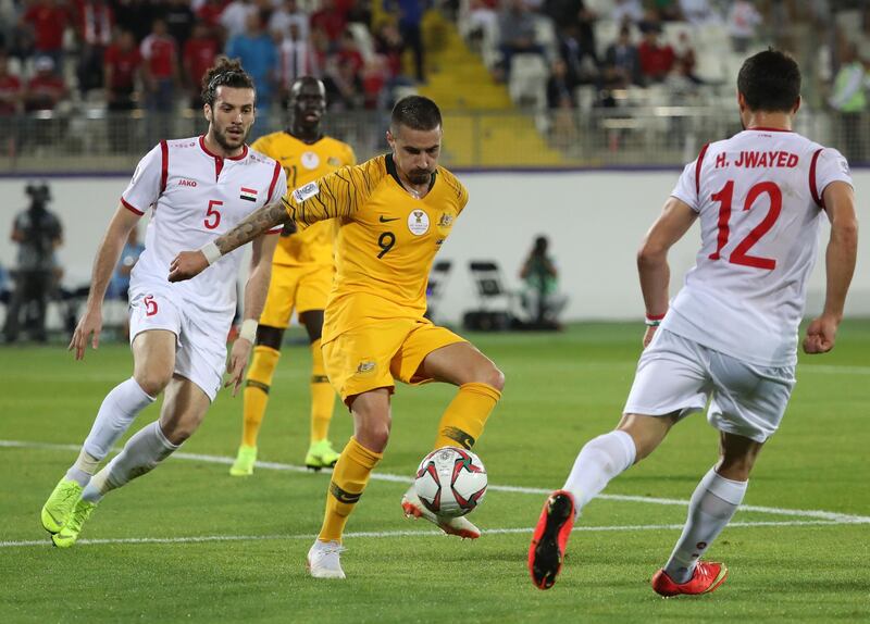 Australia's Maclaren, centre, vies for the ball against Syria's Omar Midani and Hussein Jwayed. AFP