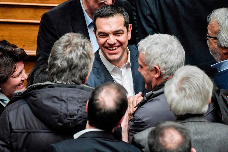 Greek Prime Minister Alexis Tsipras is congratulated after winning a confidence vote at the parliament in Athens on January 16, 2019. Tsipras survived a confidence vote after a row over a landmark name deal with Macedonia sunk his four-year coalition. A total of 151 lawmakers supported Tsipras' government, including several independent MPs, the official count showed. / AFP / LOUISA GOULIAMAKI
