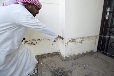 Homeowner Jasim Al Abdouli shows how deep flood waters were as they swept into his home, causing about Dh50,000 of damage to the building and possessions. Ruel Pableo for The National