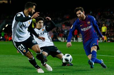 FC Barcelona's Lionel Messi, right, duels for the ball against Valencia's Carlos Soler during the Spanish Copa del Rey, semifinal, first leg, soccer match between FC Barcelona and Valencia at the Camp Nou stadium in Barcelona, Spain, Thursday, Feb. 1, 2018. (AP Photo/Manu Fernandez)
