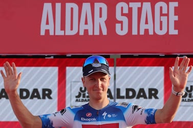 Soudal Quick–Step's Belgian cyclist Tim Merlier celebrates on the podium after winning stage 6 of the 6th UAE Cycling Tour from the Louvre Abu Dhabi to Abu Dhabi Breakwater on February 24, 2024.  (Photo by Giuseppe CACACE  /  AFP)