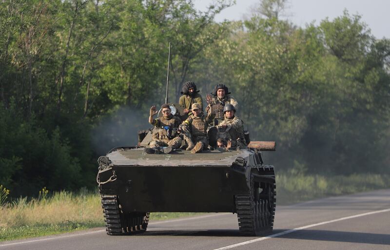 Ukrainian soldiers ride an armoured vehicle near the city of Bakhmut, in the breakaway Donetsk enclave. EPA