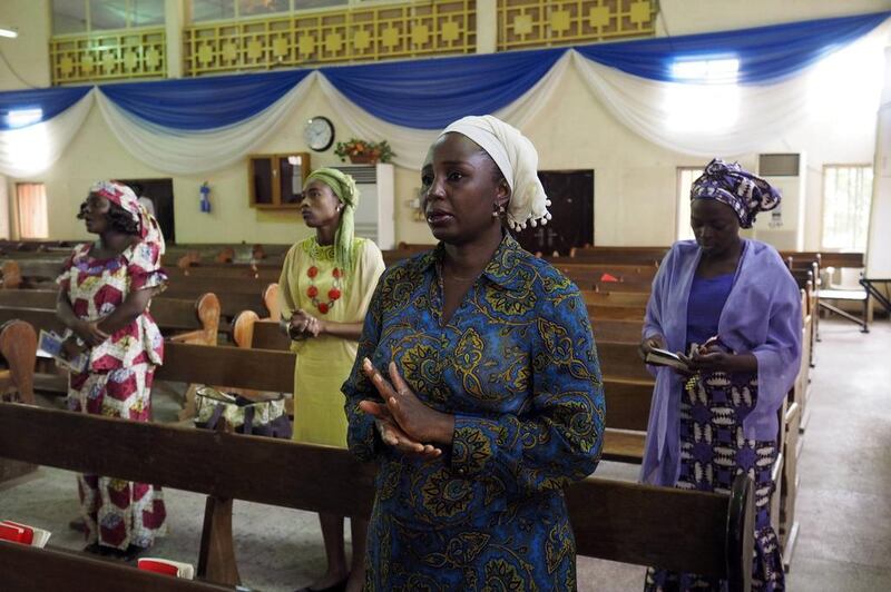 Churchgoers sing at the Evangelical Church of West Africa church in Abuja on May 11, 2014. In churches across the nation, Nigerians prayed for the safe return of the 276 girls still held captive by the Boko Haram terrorist group. Joe Penney/Reuters