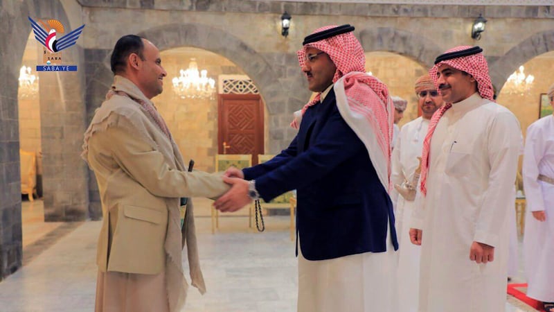 The head of the Houthis' supreme political council Mahdi Al Mashat, left, greets Saudi Arabia’s ambassador to Yemen, Mohammed Al Jaber, in Sanaa.  Photo: Houthi-run Saba news agency