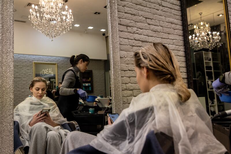 A woman gets her hair done at a beauty salon in Kiev. Getty Images