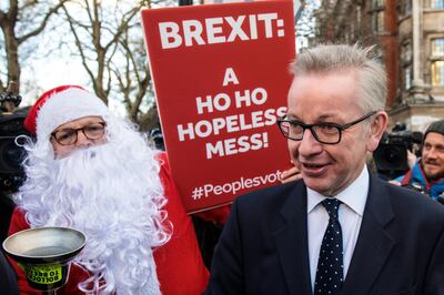LONDON, ENGLAND - DECEMBER 12: Environment Secretary Michael Gove is accosted by a protester in a Father Christmas outfit after speaking the media in Westminster on December 12, 2018 in London, England. Sir Graham Brady, the chairman of the 1922 Committee, has received the necessary 48 letters (15% of the parliamentary party) from Conservative MP's that will trigger a vote of no confidence in Prime Minister Theresa May. (Photo by Jack Taylor/Getty Images)